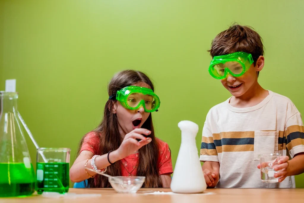 young girl and boy conducting science experiment with beakers