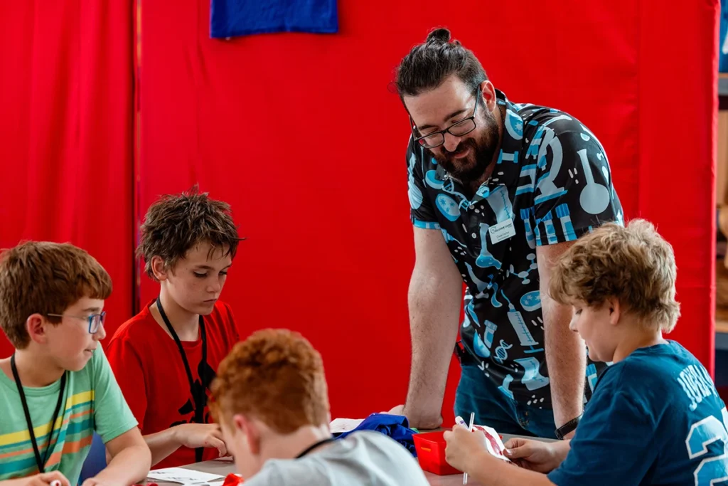 staff member works with group of 4 boys