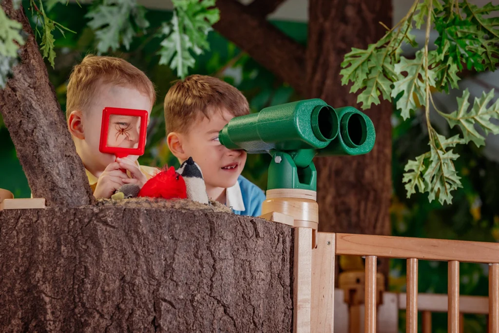 2 young boys playing in treehouse