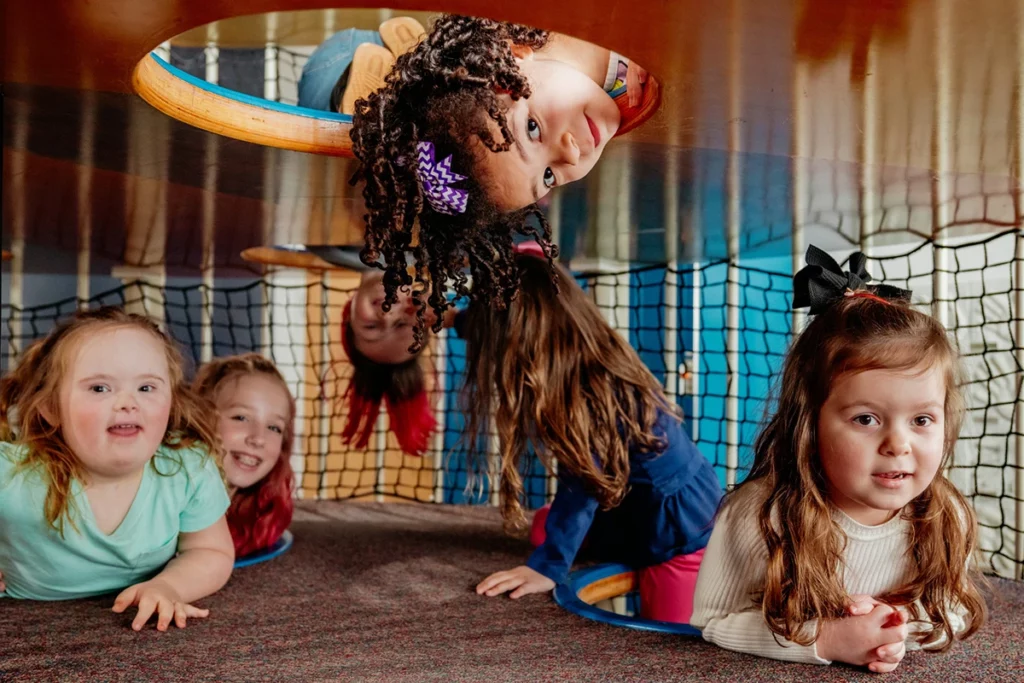 a collection of young girls play together