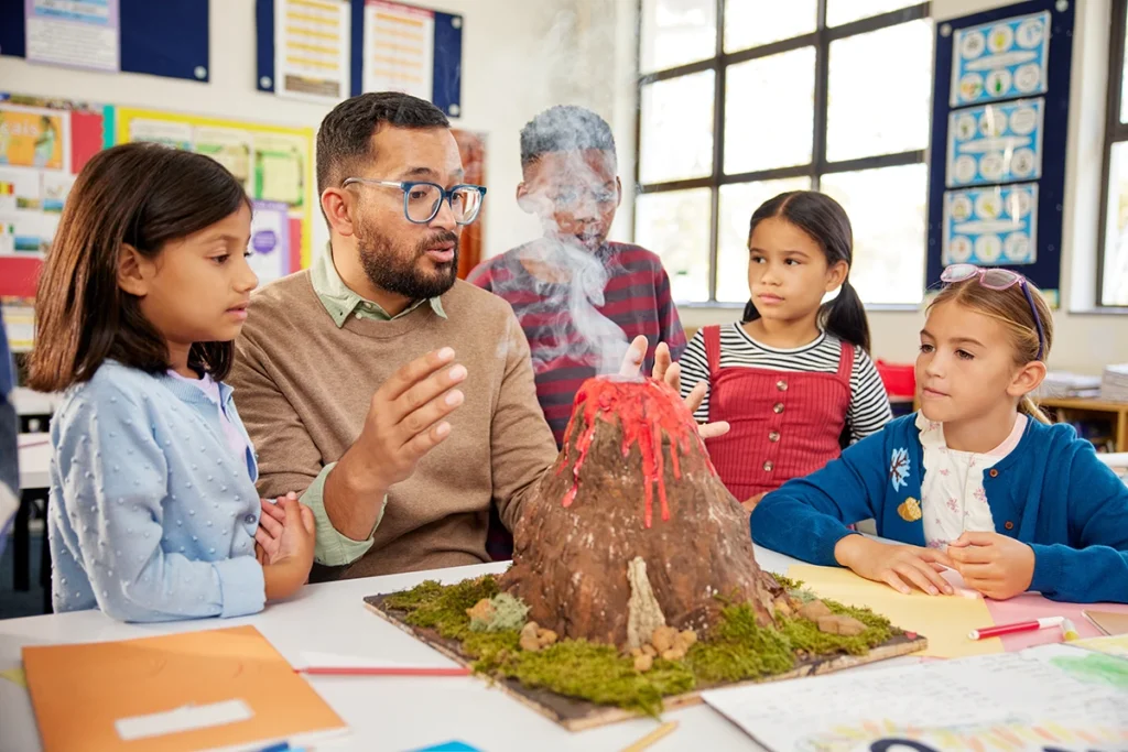 Teacher talking about volcanos with students.