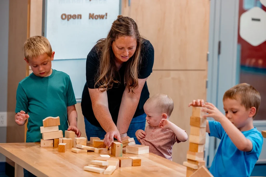 Family builds structures with wooden blocks